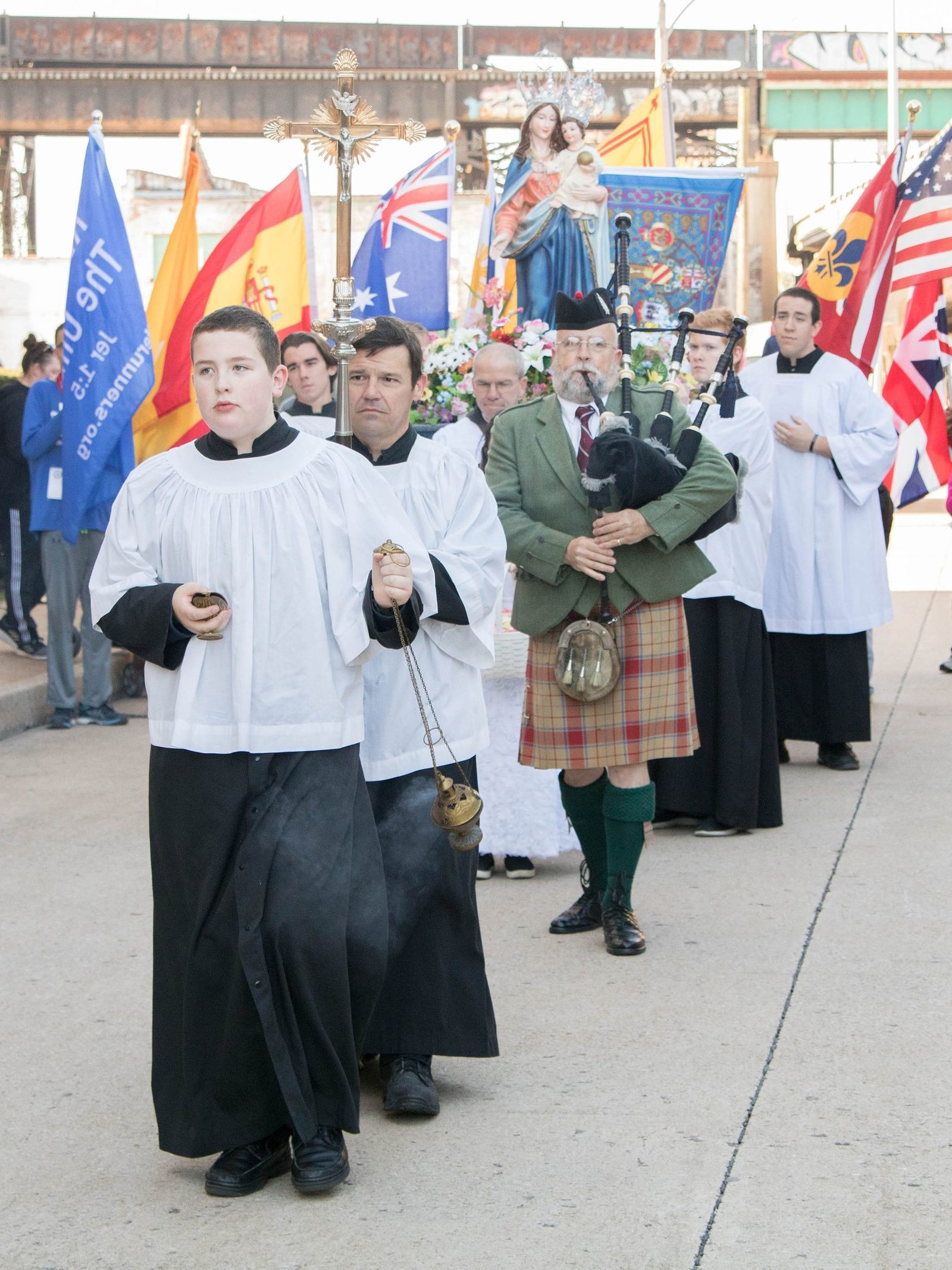 Bagpiper leads the procession